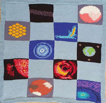 A quilted pattern depicting planets and space