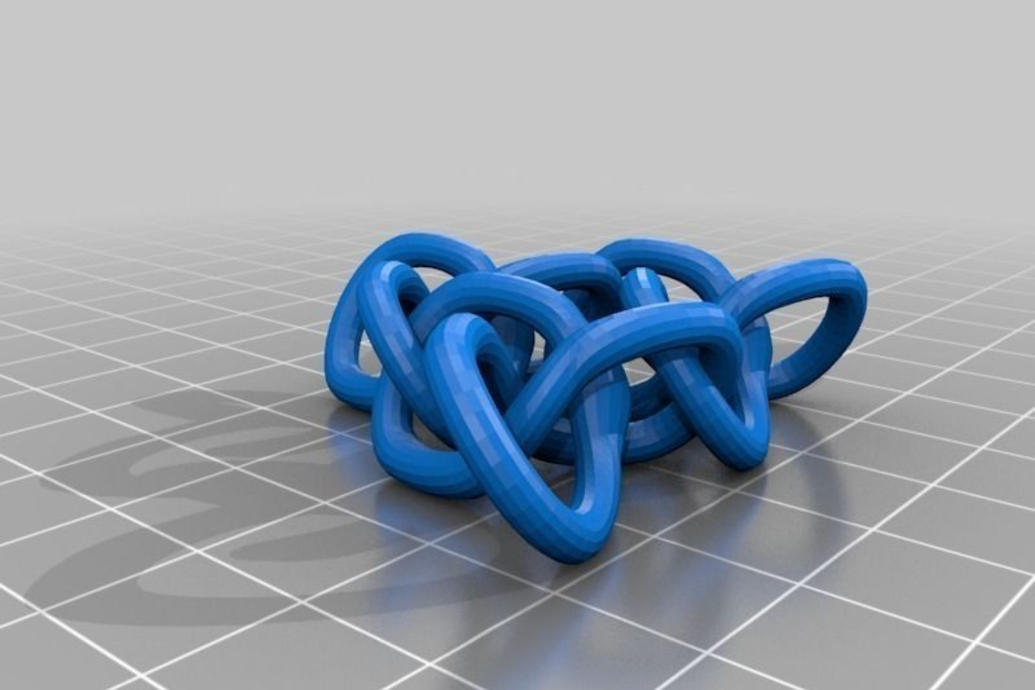A 3D print of a torus knot in blue on a grey background