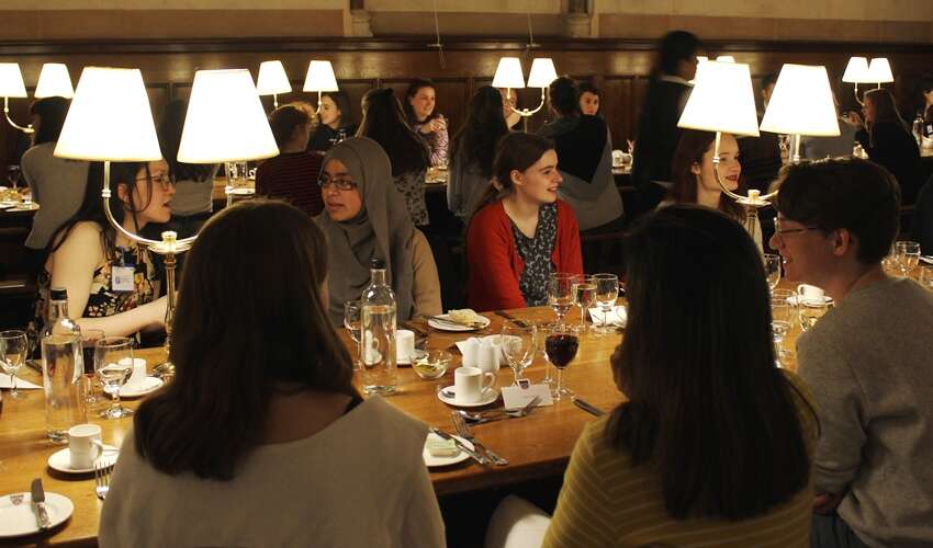 Group of women physicists having dinner