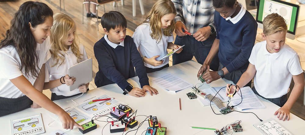 A physics teacher encourages children to explore how electricity works using simple circuits.