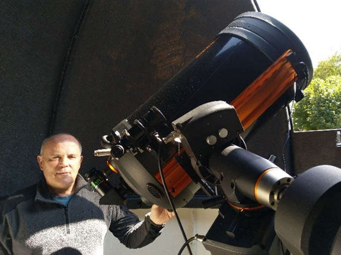 IOP fellow Lyndon Jones next to a telescope
