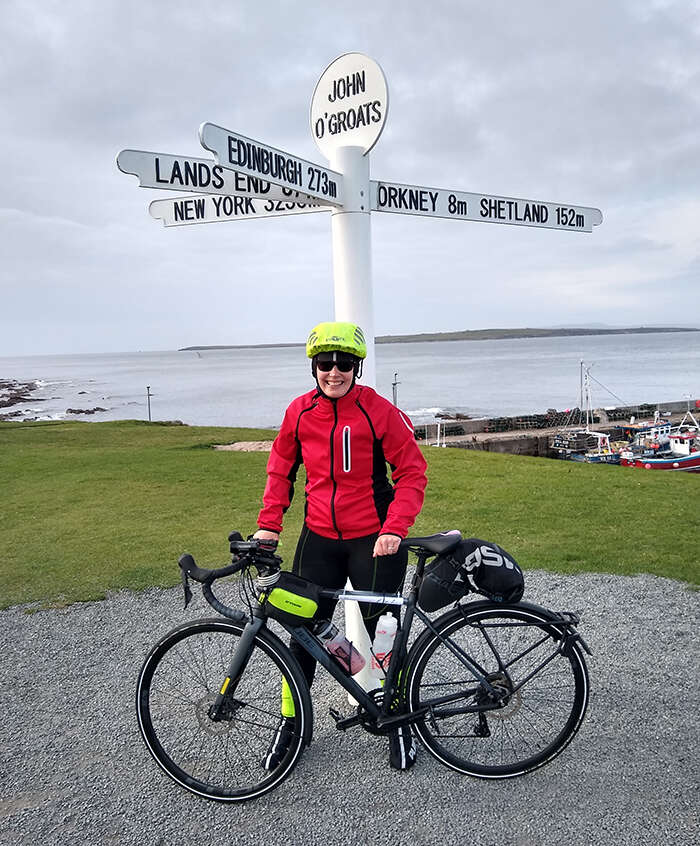 Helen Maguire at John O’Groats with her bike