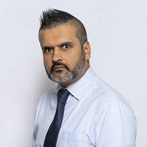 A profile of Tajinder Panesor wearing a shirt and tie