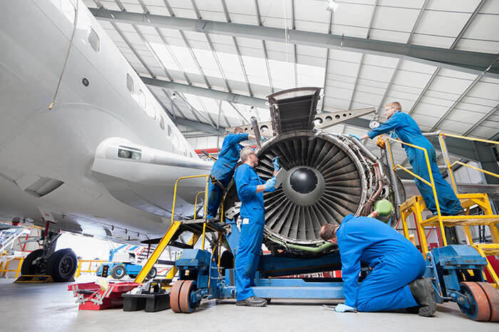 Aerospace manufacturing male workers with a jet engine