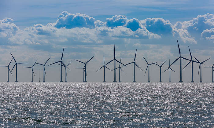 Wind turbines on a blue sea in an offshore wind farm