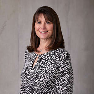 A headshot of Andrea Barber IOP head of people and organisational development smiling