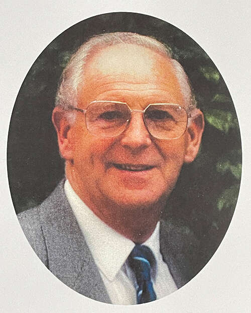 A headshot of physics teacher Jim Jardine in a suit and tie