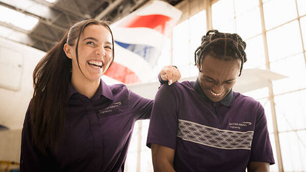 A youthful, smiling female and male who are British Airways Engineering apprentices